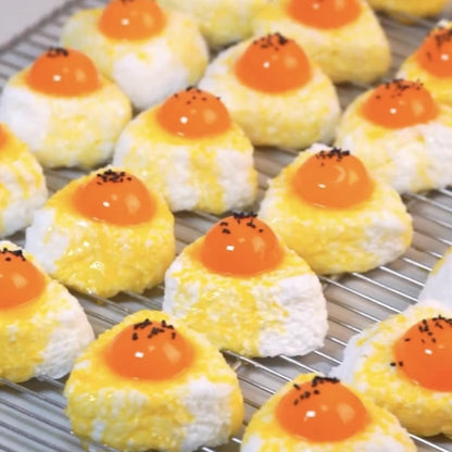 Rows of egg yolk rice ball squishies on a rack