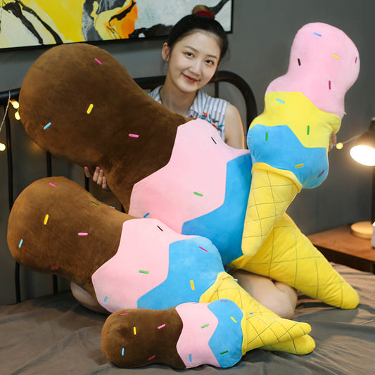 Four oversized plush ice-cream cone pillows with brown, pink and blue scoops, yellow waffle cones and multi...