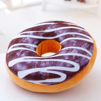 One round plush donut pillow with chocolate-brown top, white icing stripes and orange-brown base.