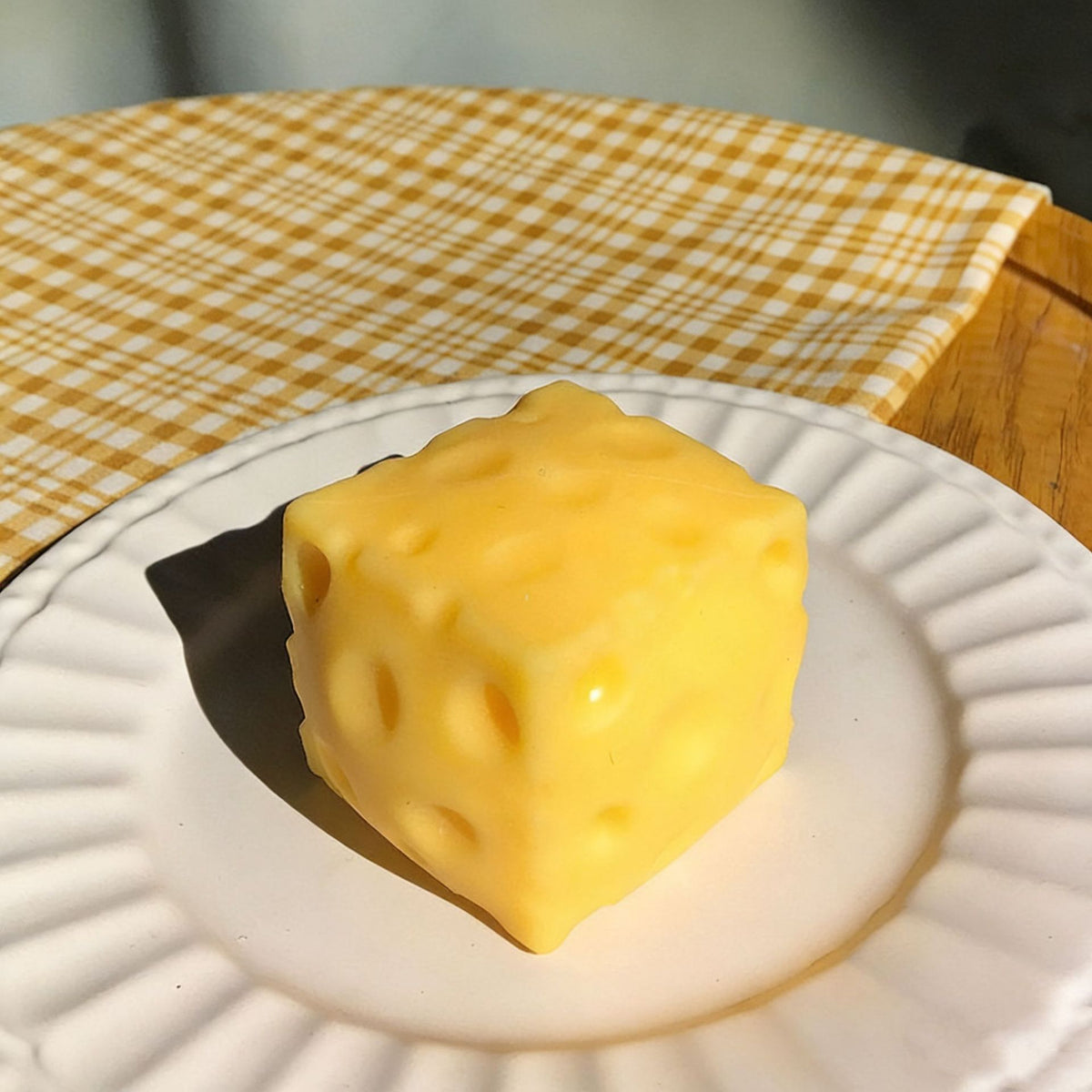 Cheese block squishy on a white plate