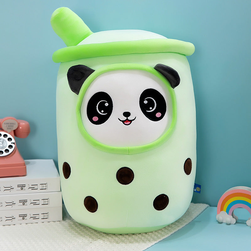 One light green plush bubble-tea cup pillow with a panda face, green straw on top and brown boba dots.