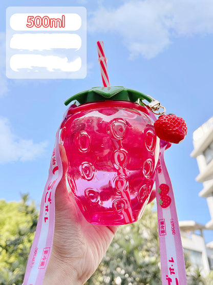 One translucent pink strawberry-shaped bottle with green lid, striped straw, strawberry charm and pink strap.