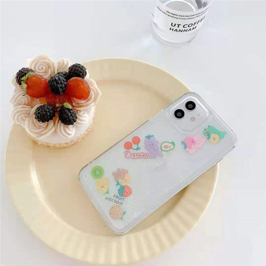 Clear iPhone case with colorful fruit and animal stickers and dual-camera cutout on yellow plate.