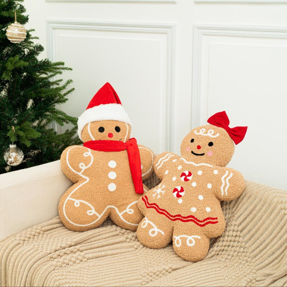 Gingerbread cookie cushions on a cream sofa by a Christmas tree