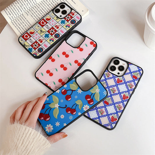 Four iPhone cases displayed, featuring cherry blossom, floral, and cherry patterns in vibrant pastel colours.