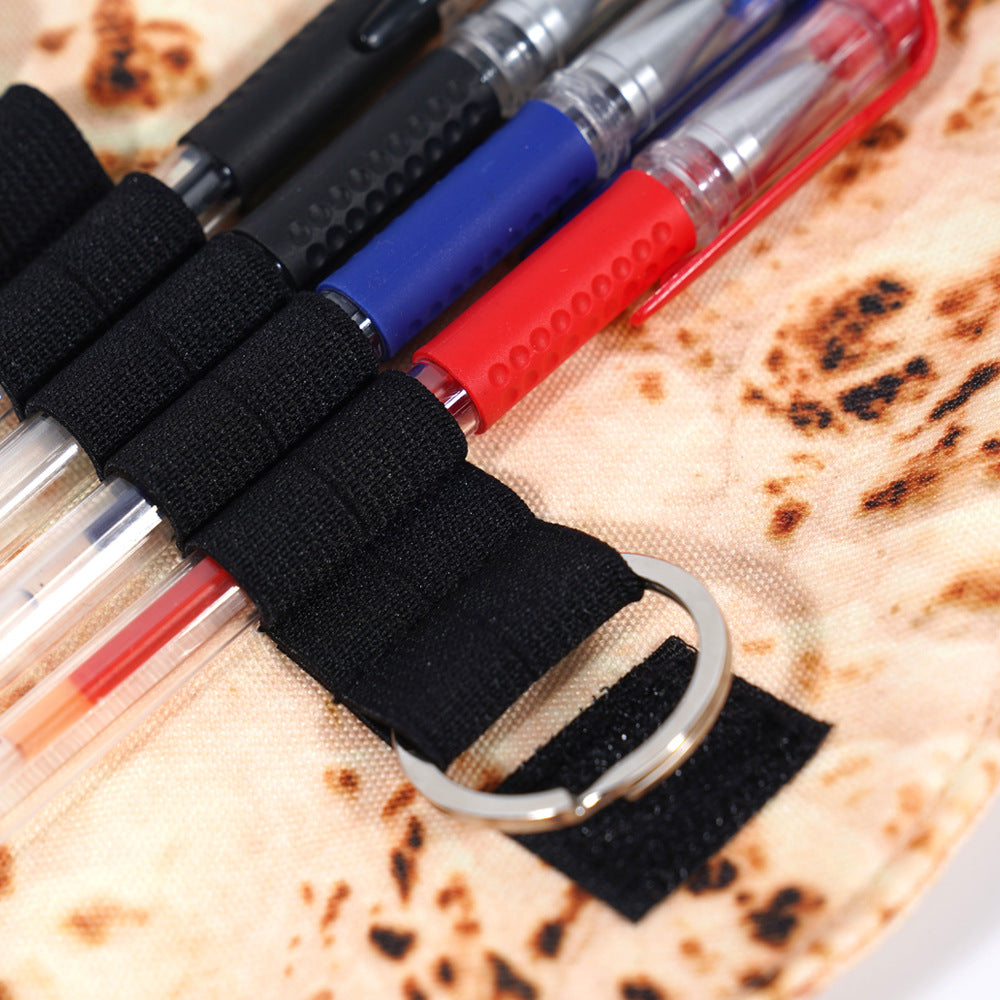 Close-up of the elastic pen strap and key ring