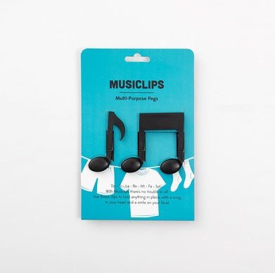 Three black music-note shaped pegs attached to a teal "MUSICLIPS" display card.