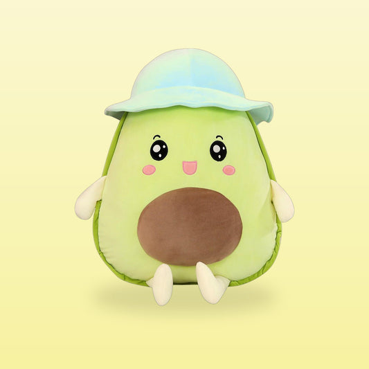 Green avocado plush toy with a pale blue bucket hat, on a butter yellow background
