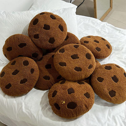 A pile of cookie cushions on a bed