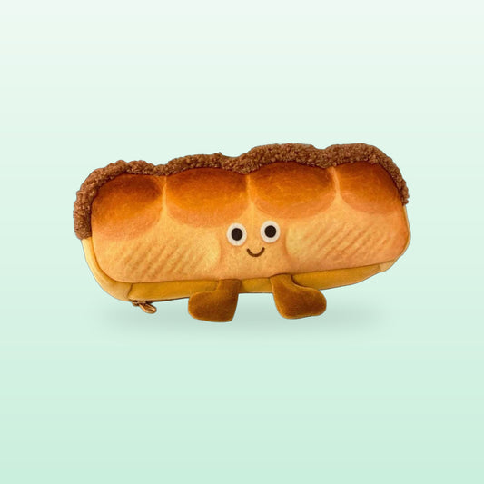 Bread loaf plush pencil case with a smiley face and little feet, on a mint green background