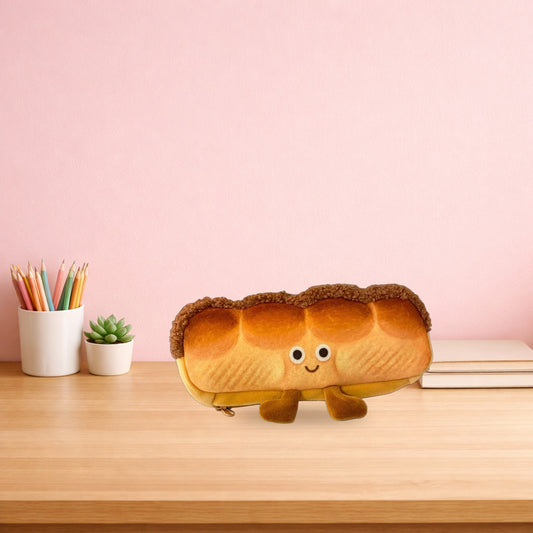 Bread loaf plush pencil case on a light oak study desk