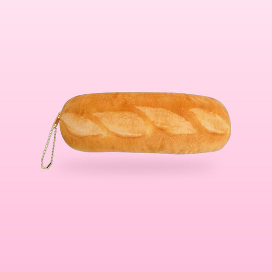 Baguette plush pencil case with a zip pull chain, on a bubblegum pink background