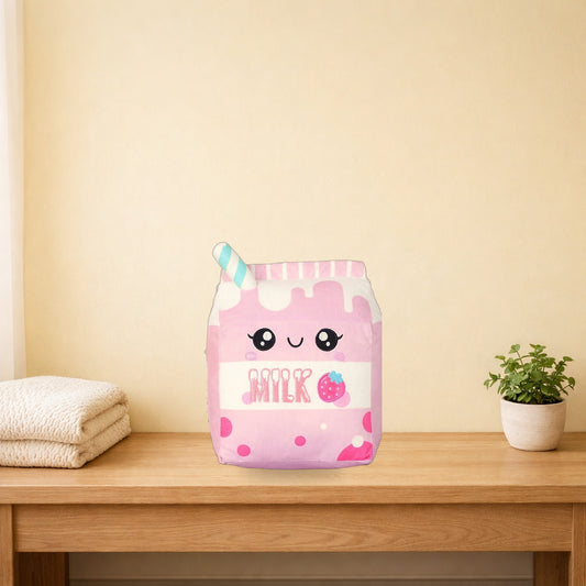 Strawberry milk carton plush pillow on a light oak bench