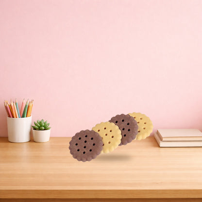 Plain and chocolate biscuit erasers standing in a row on a wooden desk