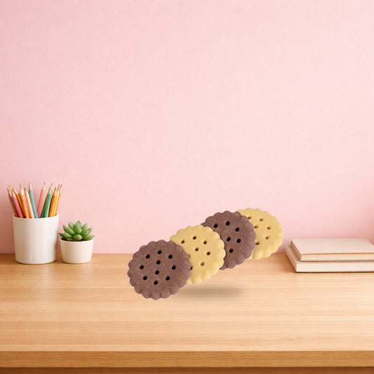 Plain and chocolate biscuit erasers standing in a row on a wooden desk