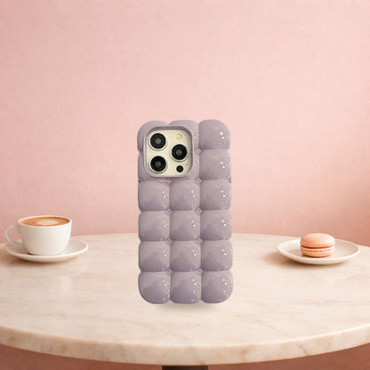 Purple bubble block iPhone case standing on a pink cafe table