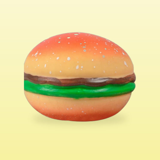 Burger stress ball with sesame bun and lettuce, on a butter yellow background