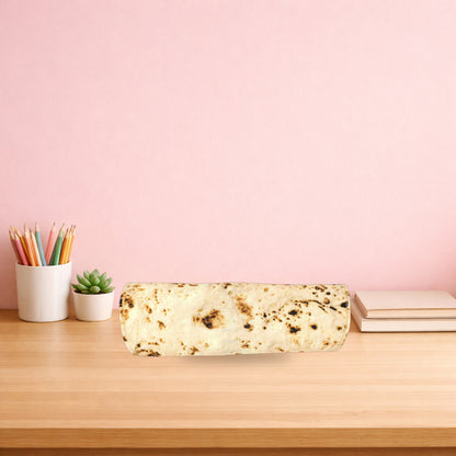 Burrito pencil case rolled up on a light oak desk