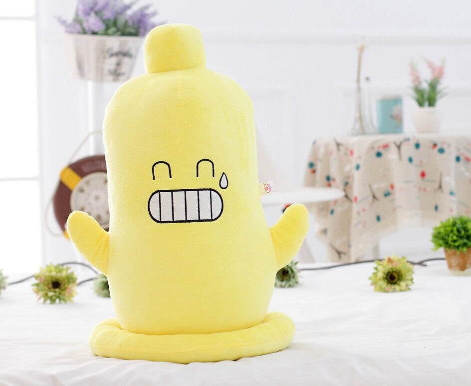 One upright yellow plush with small top knob, two arms, round base and embroidered grinning teeth and teard...