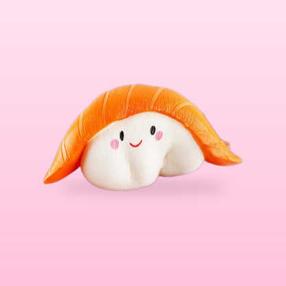 Salmon sushi squishy with a smiling face, on a bubblegum pink background