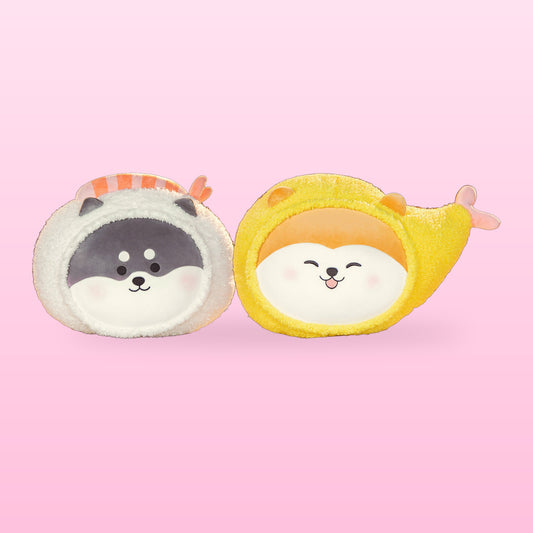 Grey shiba sushi and yellow tempura prawn plush pillows side by side, on a pink background