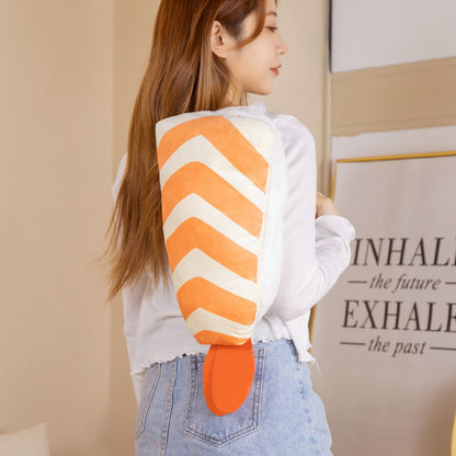 One plush orange-and-white striped backpack with orange tail flap and visible zipper, worn on woman's back.