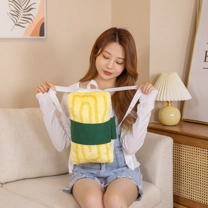 One yellow plush backpack with dark green band and white shoulder straps held by a seated woman.