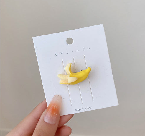 Peeled banana hair clip on its backing card