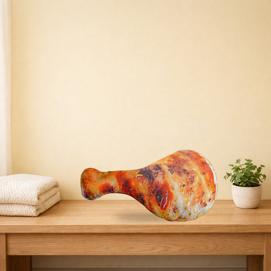 Chicken drumstick plush pillow lying on a light oak console table