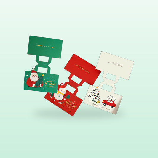 Christmas bag toppers in green, red and white with Santa, snowman and tree designs, on a soft mint background