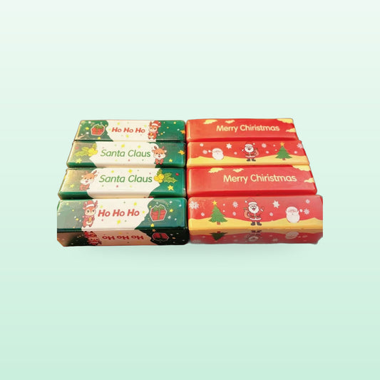 Red and green Christmas butter stick squishies with Santa Claus and Merry Christmas prints, on a mint background