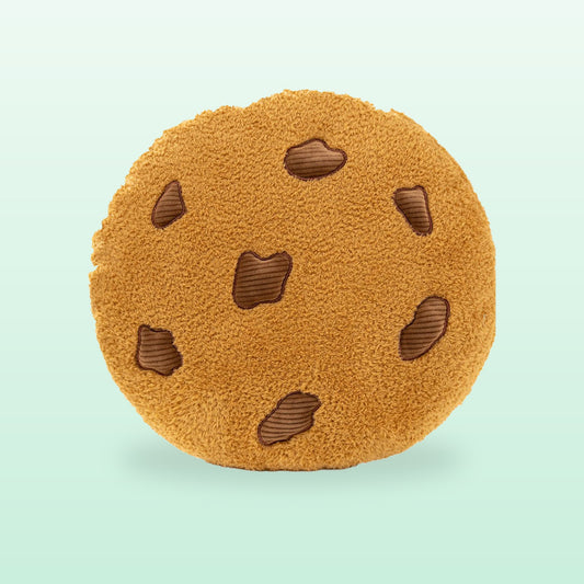Round chocolate chip cookie plush cushion, front view, on a mint green background