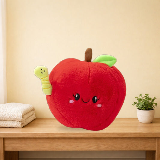 Red apple plush with a little green worm sitting on an oak bench