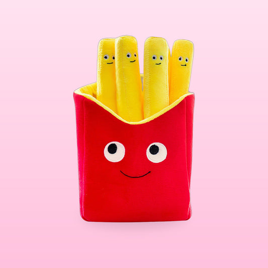 Red fries box plush pillow with four smiling yellow fries on a pink background