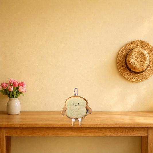 Happy Toast bread coin purse sitting on a light oak console table