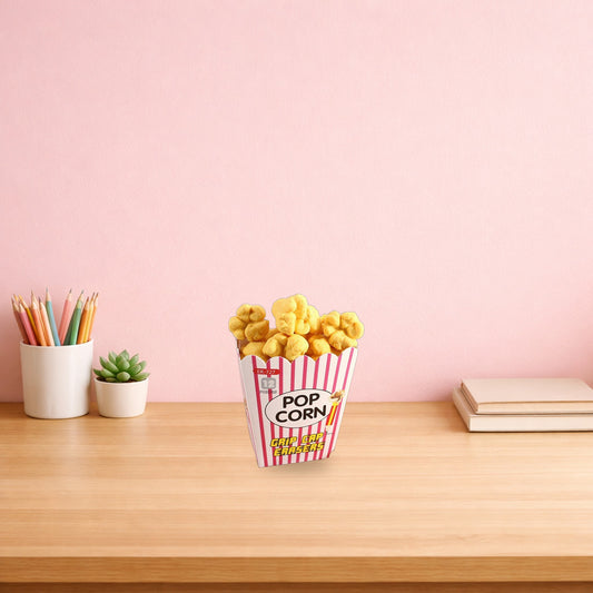 Popcorn pencil eraser box on a light oak desk