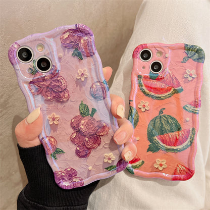 Two textured phone cases: lavender with purple flowers and white blooms; coral-pink with watermelon slices.