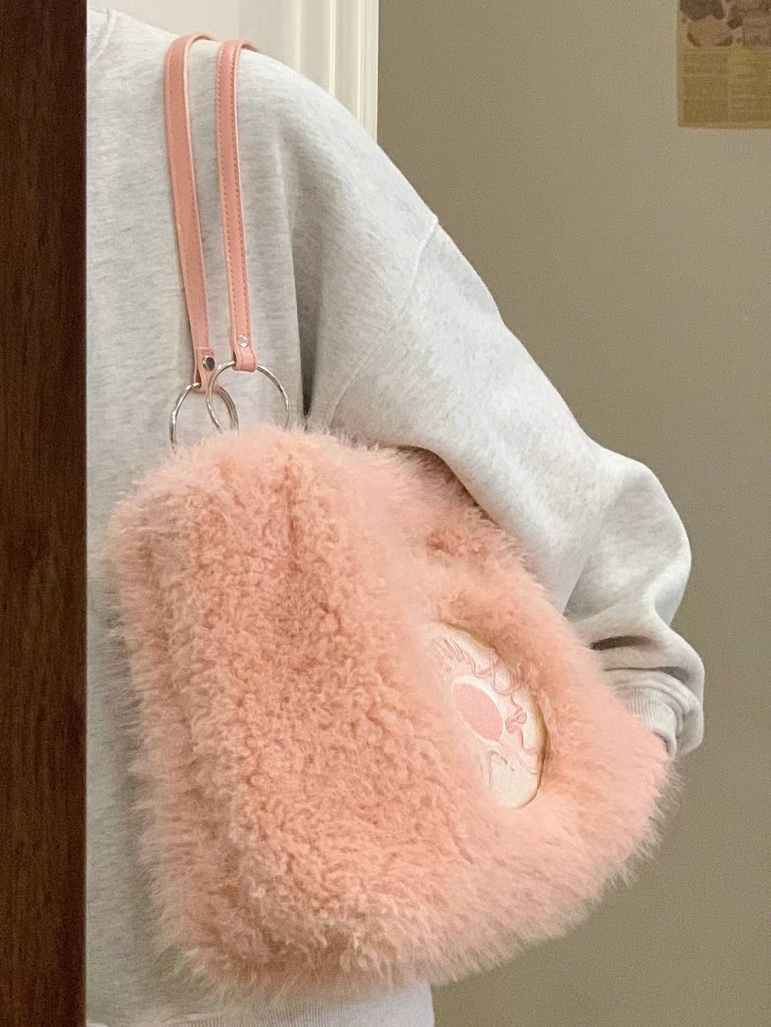 Pink fluffy tote bag with donut embroidery, featuring two light pink leather straps and a soft, textured exterior.