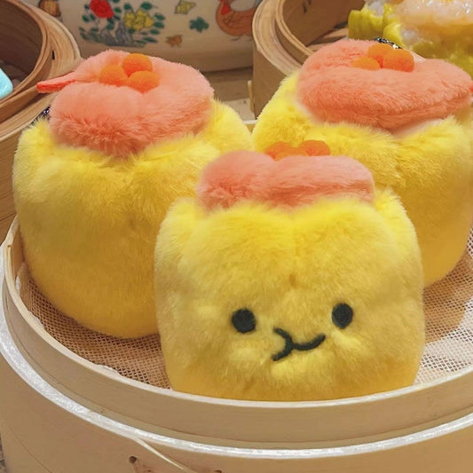 Three smiling shumai plushies in a steamer, about 8 cm each