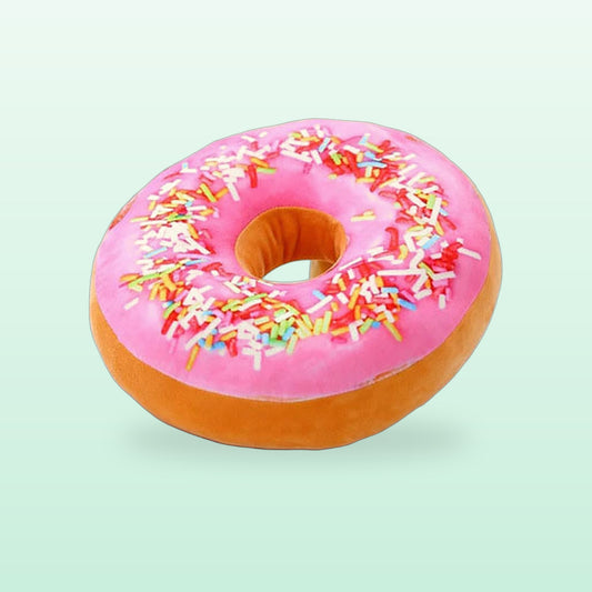 Pink Lady donut plush pillow with pink frosting and rainbow sprinkles, on a mint green background