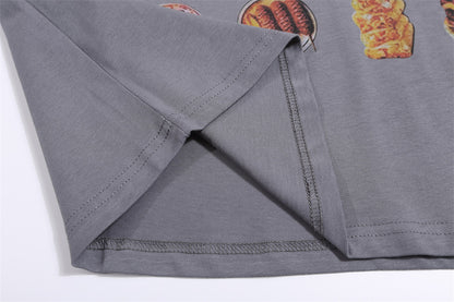 Grey T-shirt featuring vibrant BBQ food prints, showcasing burgers, sausages, and grilled meats on the fabric.
