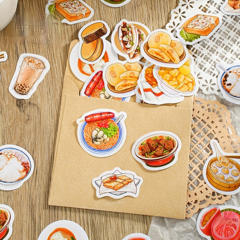 Kraft paper envelope with about 15 colorful illustrated assorted food stickers spilling on a wood table.