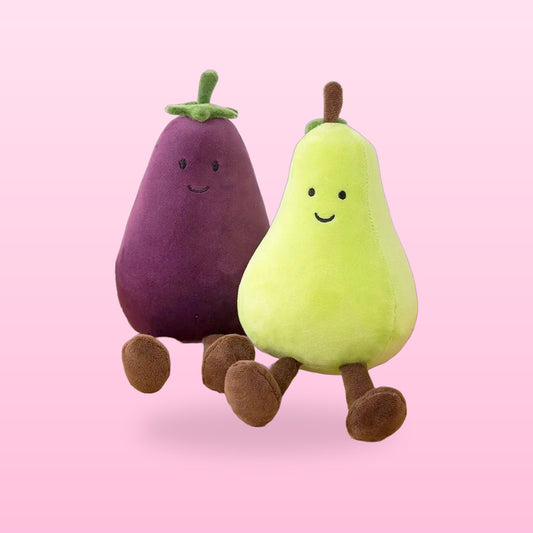 Smiling eggplant and pear plush toys sitting side by side, on a bubblegum pink background