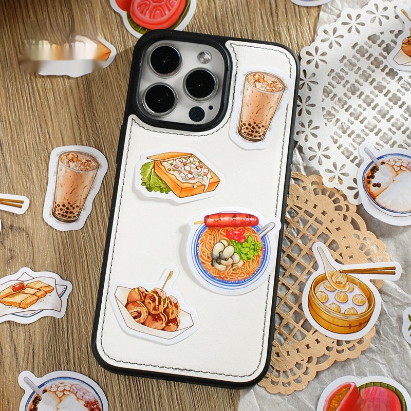 White phone with black rim and four colorful food stickers (bubble tea, toast, ramen, takoyaki) on wood.