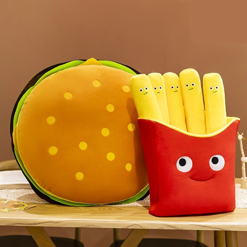 Round burger plush pillow beside the red fries box plush on a wooden table