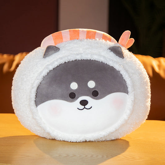 One round plush with grey-and-white smiling animal face, fluffy white border and orange-striped top.