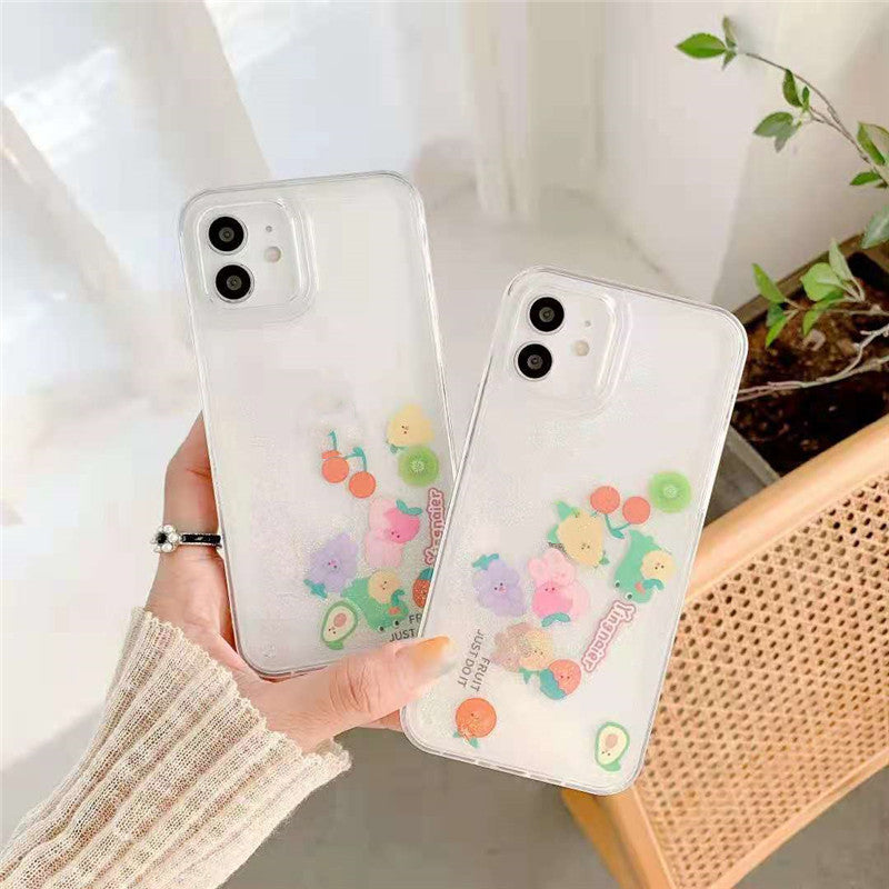 Two clear glitter iPhone cases held in one hand, each with pastel cartoon fruit stickers and camera cutouts.