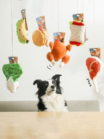 Border collie staring at six hanging plush food toys: lettuce, taco, burger, roast chicken, sandwich, drums...