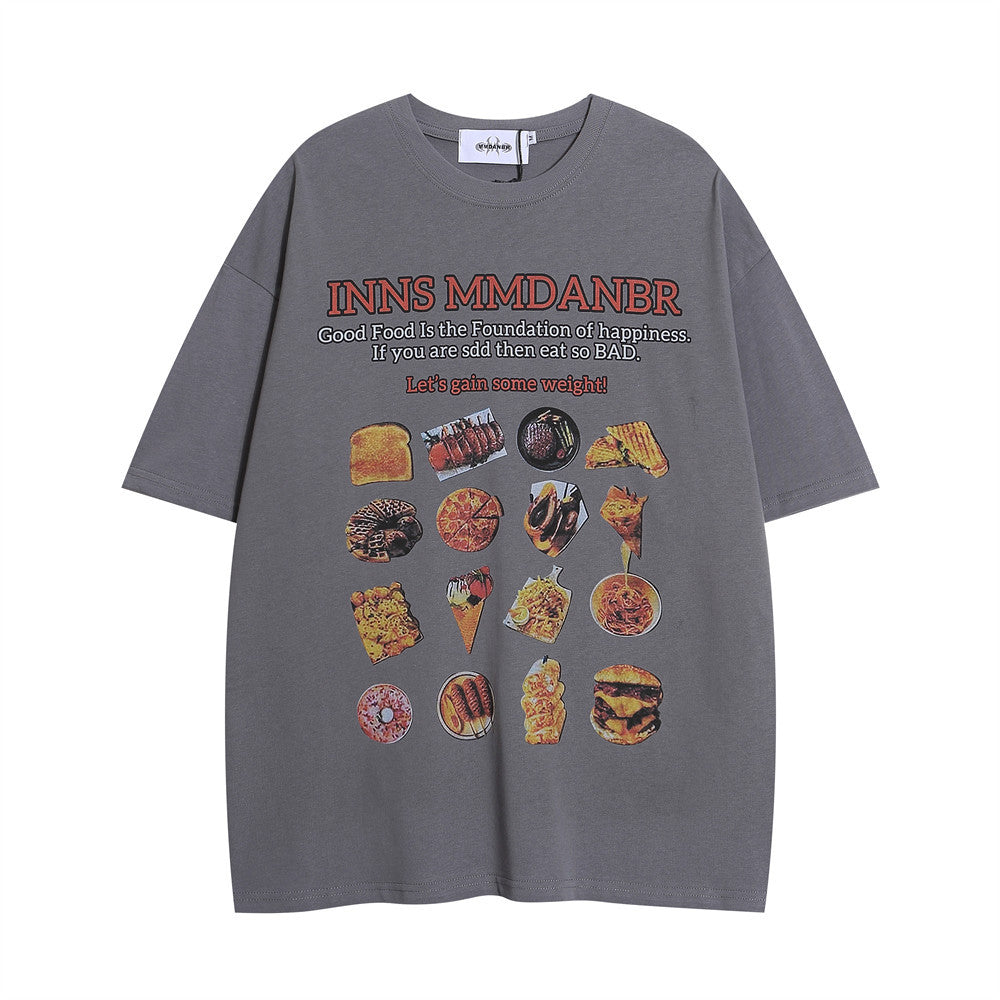 Grey oversized T-shirt featuring a BBQ food print, with colourful illustrations and playful text about enjoying food.