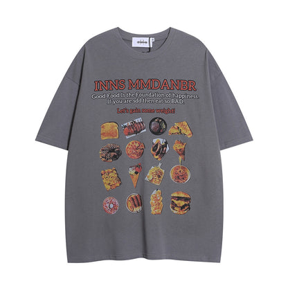 Grey oversized T-shirt featuring a BBQ food print, with colourful illustrations and playful text about enjoying food.